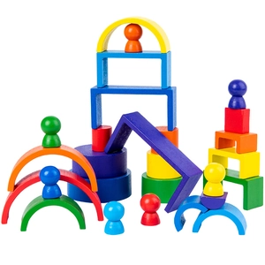 Close-up of colorful wooden rainbow blocks with nesting cups and peg dolls for kids