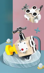 Detail of wooden Montessori busy cube featuring a metal faucet handle and a fidget spinner