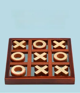 Close-up of vintage wooden Tic-Tac-Toe board with X and O pieces on blue background