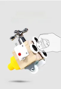 Detail of wooden busy cube with metal faucet handle and spinner for motor skills