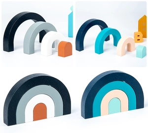 Detail of wooden rainbow stacker blocks in two soft color palettes for child education