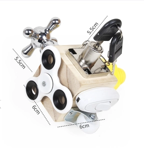 Detail view of Montessori wooden busy cube showing faucet switch and spinner components
