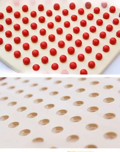 Close-up of Montessori wooden multiplication board with red beads and natural wood slots