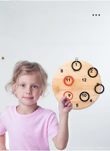 Close-up of wooden ring toss board with 13 numbered hooks and rubber rings for kids