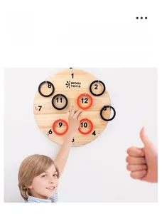 Close-up of child playing wooden ring toss board with numbered hooks and plastic rings