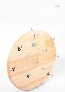 Macro detail of wooden hook and ring toss board with thirteen numbered metal hooks