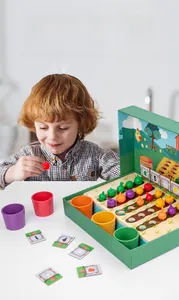 Toddler playing with wooden vegetable farm sorting toy including colored cups and cards