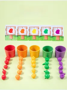 Detail of color sorting cups and assorted plastic fruit toy set for toddler learning