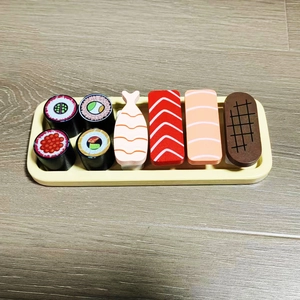 Macro view of wooden sushi toy set with tray, featuring realistic hand-painted details