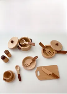 Flat lay of a premium wooden toy kitchen set with pans, utensils, and dining accessories