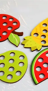 Close-up of wooden fruit threading toys showing vivid heat transfer printing details