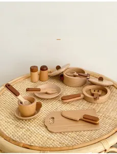 Close-up of wooden pretend play kitchen cookware set with smooth polished finish
