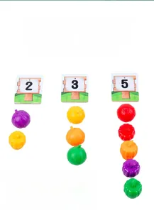 Detail of wooden vegetable counting toy showing addition logic with colorful pumpkins