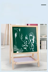 Detail of the black chalkboard side on a wooden easel with a white storage tray