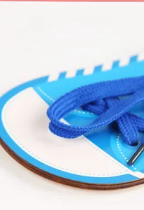 Detail of laser-cut wooden lacing board toy with blue woven shoelace for kids