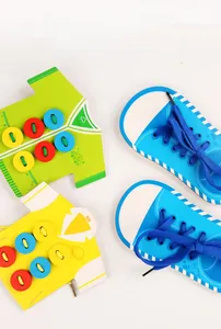Detail of wooden threading toy board showing shirts and shoes with colorful cartoon prints