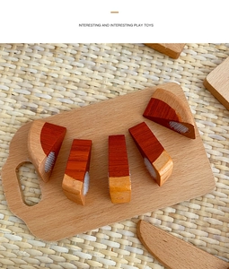 Detail of wooden cutting board and velcro vegetable pieces for kids play kitchen set