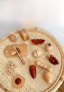 Detailed view of natural wooden play food set with toy knife and cutting board