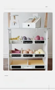 Close-up of wooden toy supermarket shelves with cash register and colorful play fruit