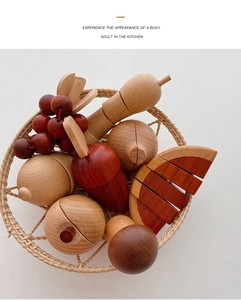Macro shot of wooden play fruit set with carrot and apple in a woven basket