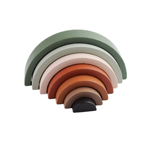 Macro shot of 7-layer wooden rainbow stacker toy with matte finish in earth tones