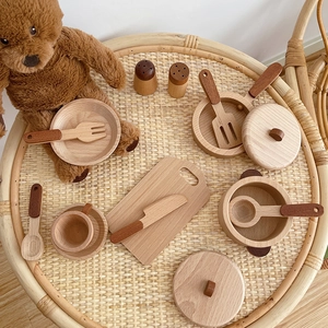 Children's wooden kitchen play set with pots and utensils in a warm home setting