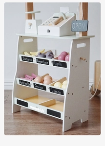 Detail of wooden kids supermarket playset with fruit models and a cashier toy