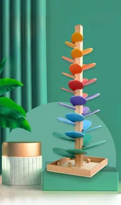 Macro detail of wooden rainbow music tree toy showing colorful petals and rolling marbles
