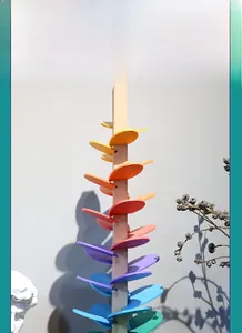 Detailed view of colorful wooden rainbow music tree toy with vibrant gradient petal leaves