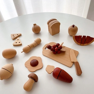 Macro detail of wooden toy food set with cutting board on a white table