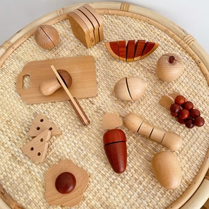 Top view of wooden play food set with toy knife and fruits on a woven tray