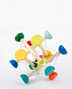 Macro detail of wooden sensory grasping ball with colorful beads and elastic strings