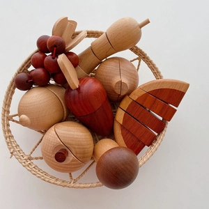 Close-up of wooden pretend play fruit and vegetable set in a small woven basket