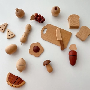 Flat lay of wooden play food set including sliced fruits, vegetables and knife