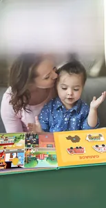 Toddler busy book featuring interactive emergency vehicle scenes with mother and child
