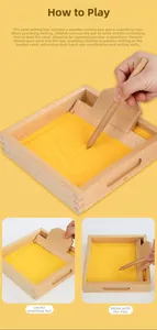 Macro view of Montessori wooden sand tray set with yellow sand and stylus tool