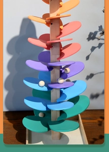 Detailed macro view of the colorful wooden marble run tree toy with rainbow petal tracks