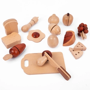 Detailed wooden play food set with carrot, apple, and knife on a white background