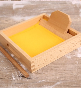 Macro view of Montessori wooden sand tray set for children handwriting practice