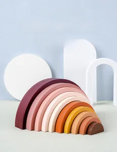 Detailed view of Morandi color wooden rainbow stacking blocks on minimalist display props