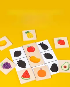 Close-up of wooden fruit matching blocks and shadow training cards for early education