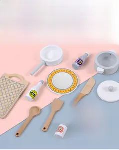 Detailed overhead view of wooden play kitchen accessories including pots and utensils