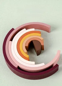 Macro detail of Morandi color wooden rainbow stacking blocks with smooth rounded edges