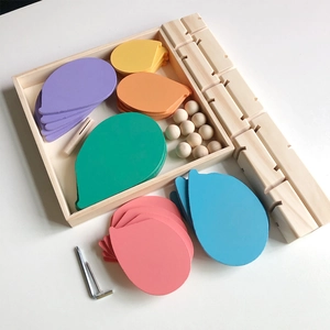 Detailed view of colorful drop-shaped wooden blocks and assembly tools for musical tree toy