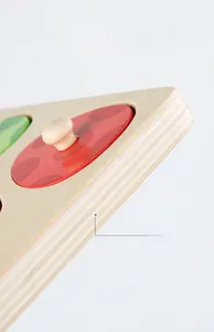 Close-up of wood dinosaur puzzle pieces showing high-density layers and round handles