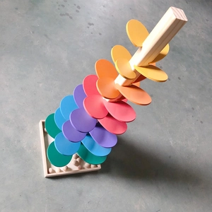 Detailed 45-degree view of rainbow wooden music tree toy with marble run petals