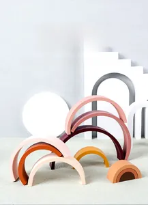 Detailed view of Morandi rainbow wooden blocks on minimalist artistic geometric stands