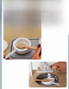 Detail view of a wooden toy kitchen set with realistic stove and stainless steel sink