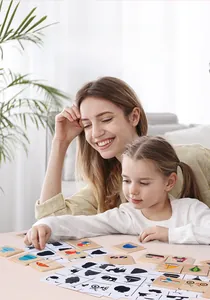 Close-up of mother and daughter playing with wooden shadow matching puzzle for kids