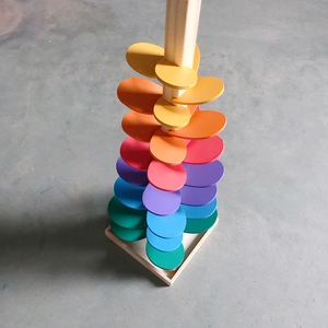 Macro view of wooden rainbow singing tree toy with colorful gradient spiral leaves